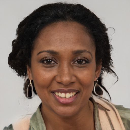 Joyful black adult female with medium  brown hair and brown eyes