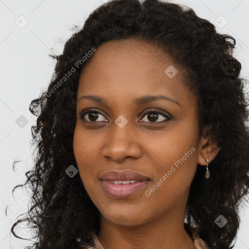 Joyful black young-adult female with long  brown hair and brown eyes