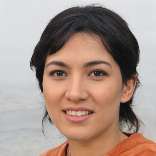 Joyful asian young-adult female with medium  black hair and brown eyes