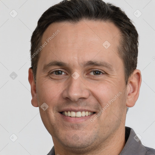 Joyful white adult male with short  brown hair and brown eyes