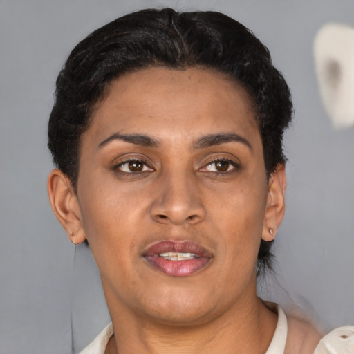 Joyful latino adult female with short  brown hair and brown eyes