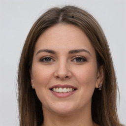 Joyful white young-adult female with long  brown hair and grey eyes