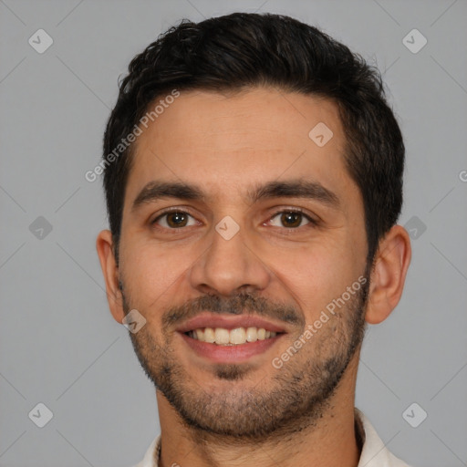 Joyful white young-adult male with short  black hair and brown eyes