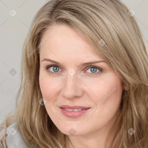 Joyful white young-adult female with long  brown hair and blue eyes