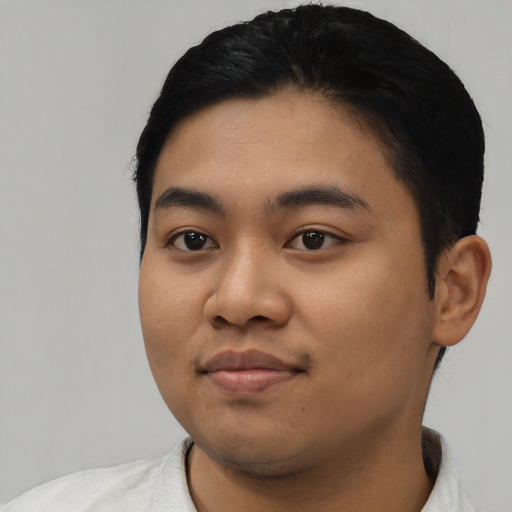 Joyful asian young-adult male with short  black hair and brown eyes