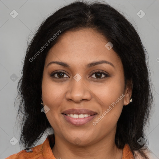 Joyful latino adult female with medium  brown hair and brown eyes