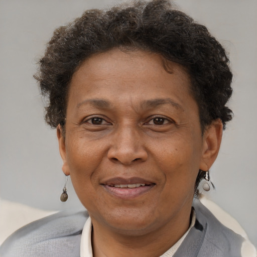 Joyful black adult female with short  brown hair and brown eyes