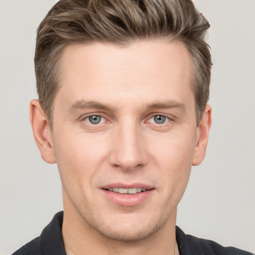 Joyful white adult male with short  brown hair and grey eyes