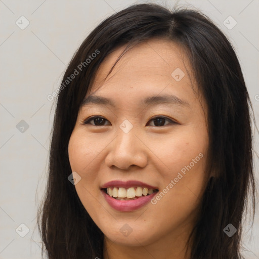 Joyful asian young-adult female with long  brown hair and brown eyes