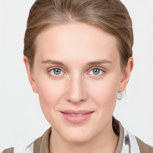 Joyful white young-adult female with medium  brown hair and blue eyes