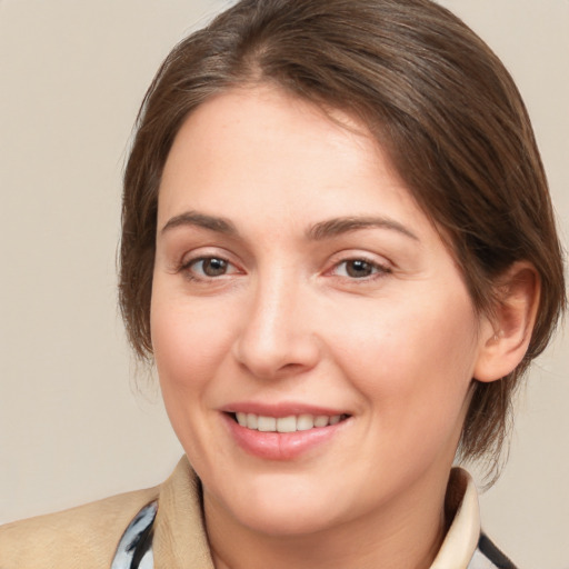 Joyful white young-adult female with medium  brown hair and brown eyes