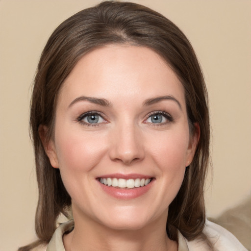 Joyful white young-adult female with medium  brown hair and grey eyes