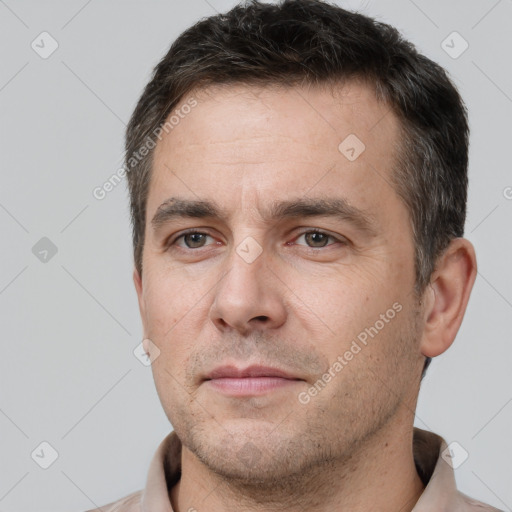 Joyful white adult male with short  brown hair and brown eyes