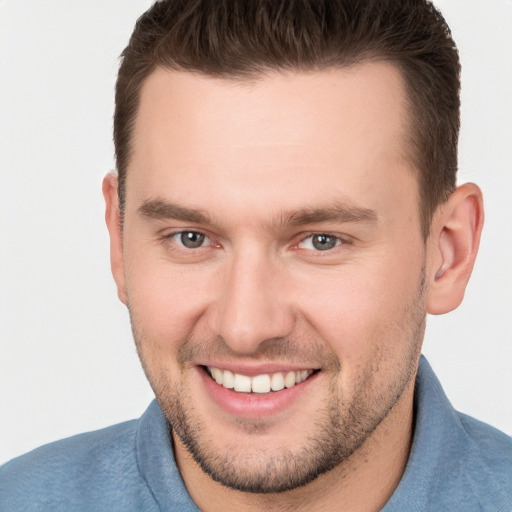 Joyful white young-adult male with short  brown hair and brown eyes