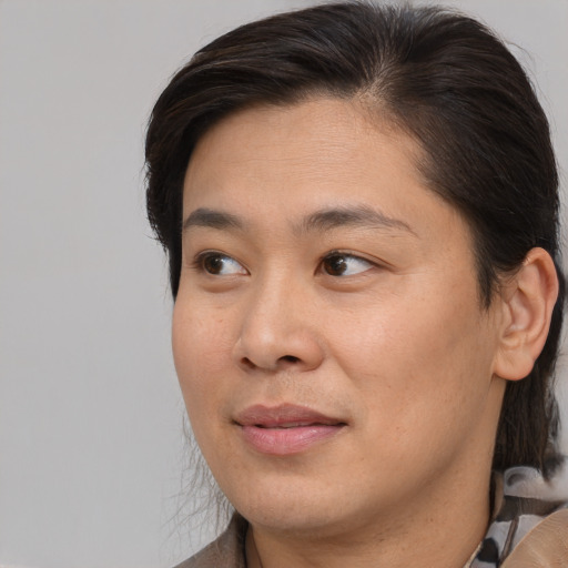 Joyful asian young-adult female with medium  brown hair and brown eyes