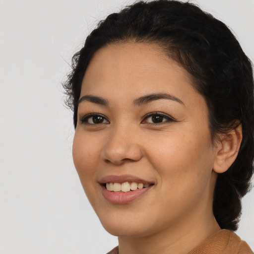 Joyful latino young-adult female with medium  black hair and brown eyes