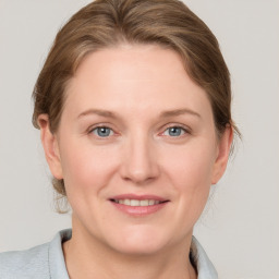 Joyful white adult female with medium  brown hair and grey eyes