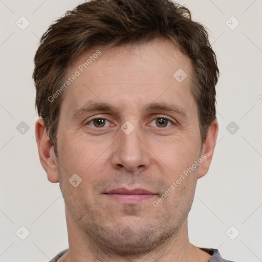 Joyful white adult male with short  brown hair and grey eyes