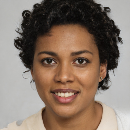 Joyful black young-adult female with short  brown hair and brown eyes