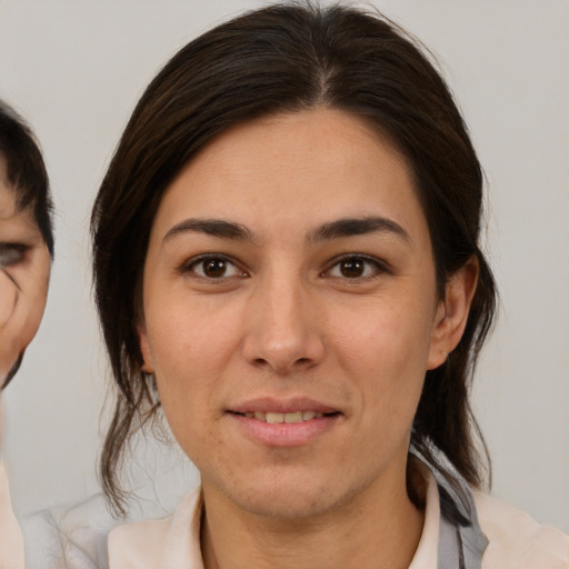 Joyful white young-adult female with medium  brown hair and brown eyes