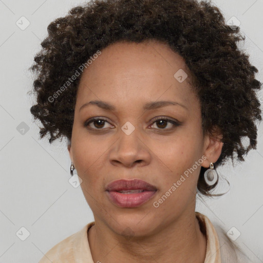 Joyful black adult female with short  brown hair and brown eyes