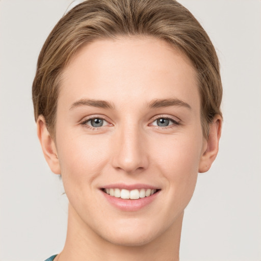 Joyful white young-adult female with medium  brown hair and grey eyes