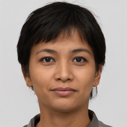 Joyful asian young-adult female with short  brown hair and brown eyes