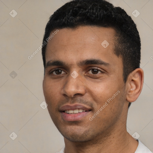 Joyful black young-adult male with short  black hair and brown eyes