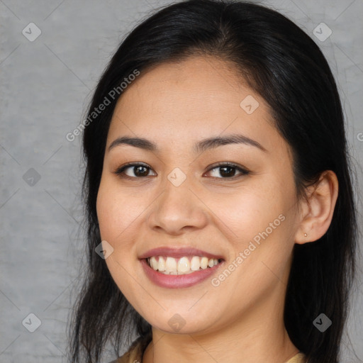 Joyful latino young-adult female with long  brown hair and brown eyes