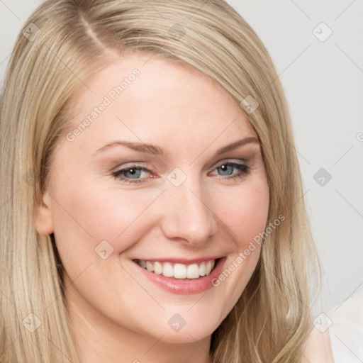 Joyful white young-adult female with long  brown hair and blue eyes