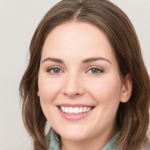 Joyful white young-adult female with medium  brown hair and green eyes