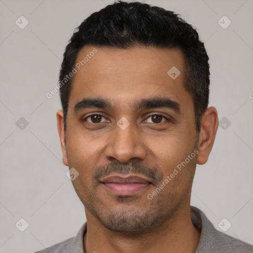 Joyful latino young-adult male with short  black hair and brown eyes