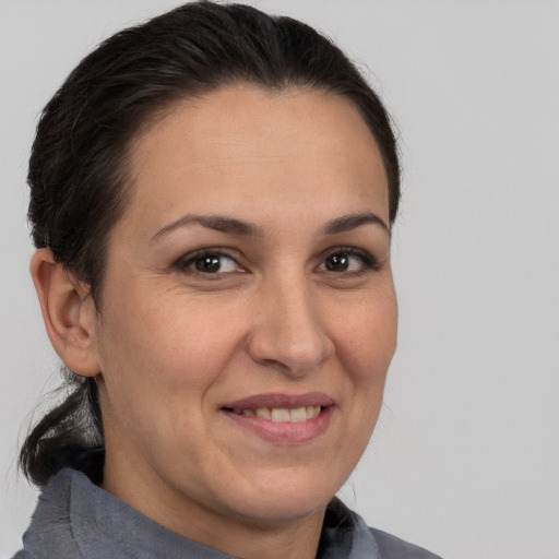 Joyful white adult female with medium  brown hair and brown eyes