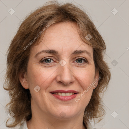 Joyful white adult female with medium  brown hair and grey eyes