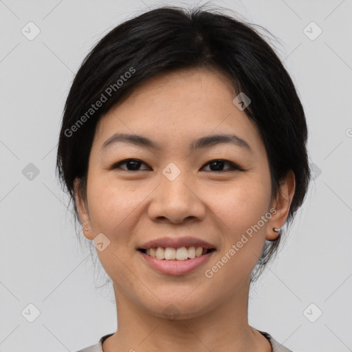 Joyful asian young-adult female with medium  black hair and brown eyes