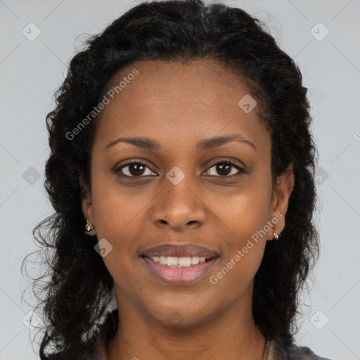 Joyful black young-adult female with long  brown hair and brown eyes