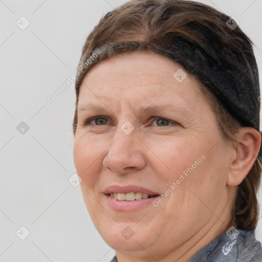 Joyful white adult female with medium  brown hair and grey eyes