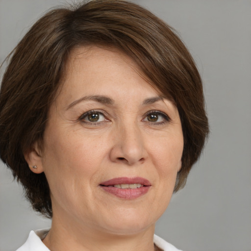 Joyful white adult female with medium  brown hair and brown eyes