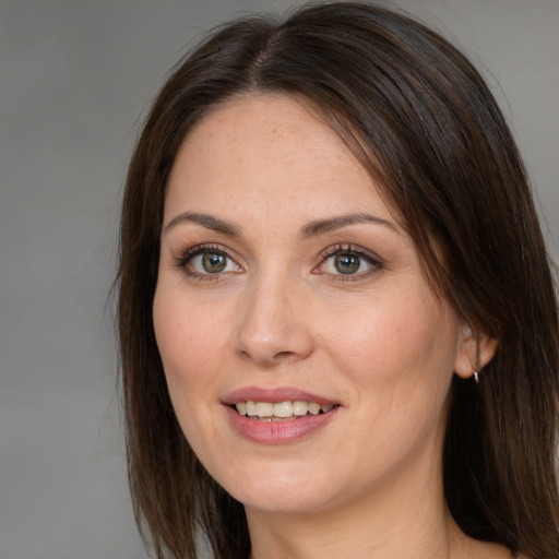 Joyful white adult female with medium  brown hair and grey eyes