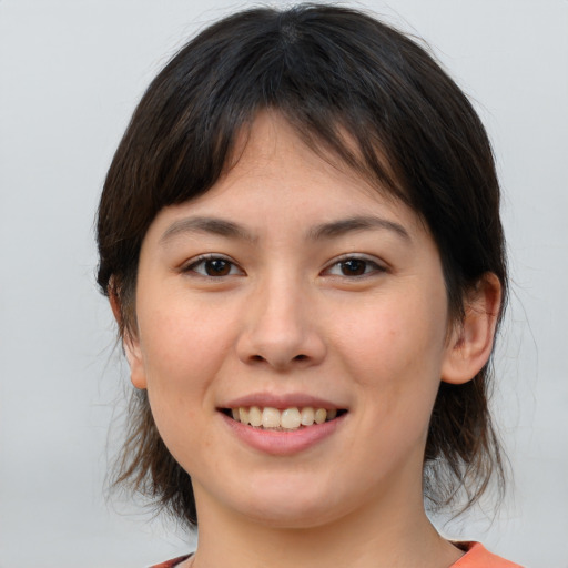 Joyful white young-adult female with medium  brown hair and brown eyes