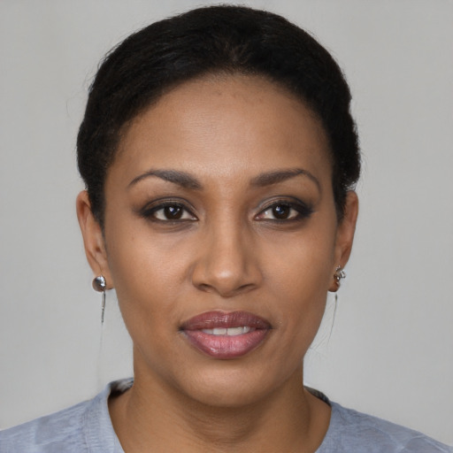 Joyful black young-adult female with short  brown hair and brown eyes