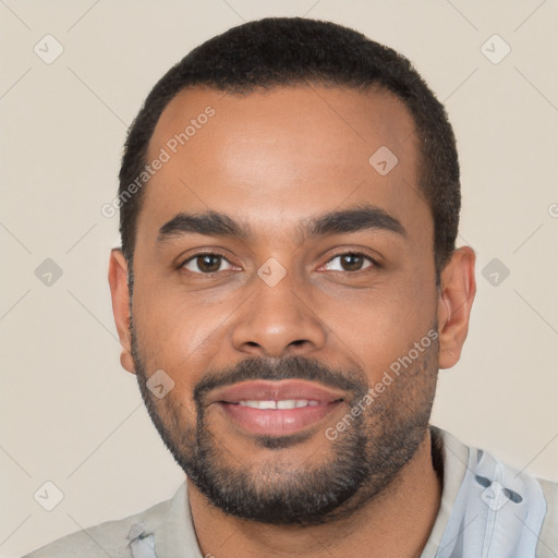 Joyful black young-adult male with short  black hair and brown eyes