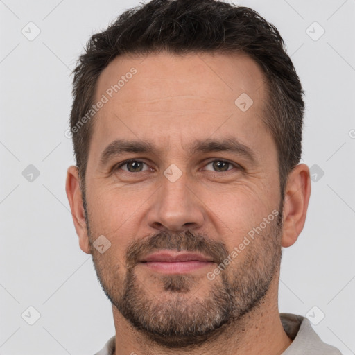 Joyful white adult male with short  brown hair and brown eyes