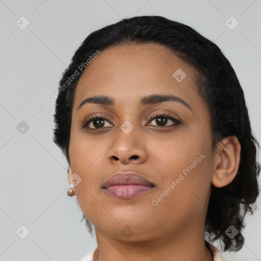 Joyful black young-adult female with short  black hair and brown eyes