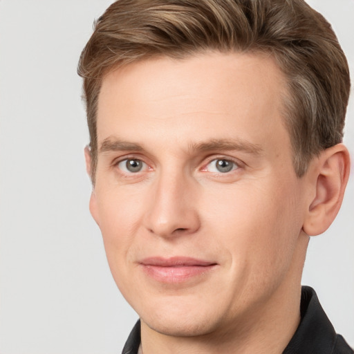 Joyful white adult male with short  brown hair and grey eyes