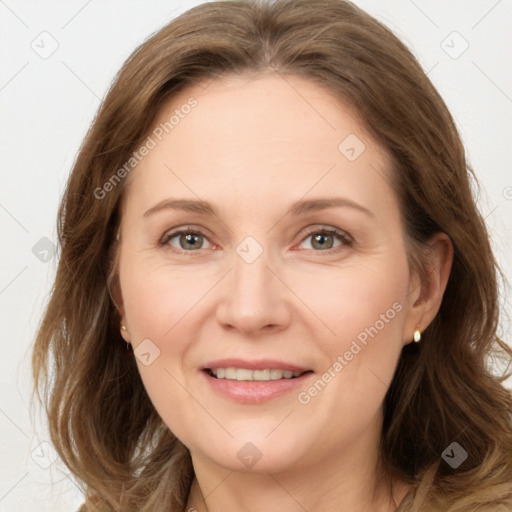 Joyful white adult female with long  brown hair and grey eyes