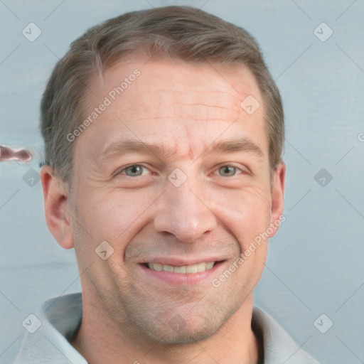 Joyful white adult male with short  brown hair and grey eyes