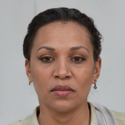 Joyful latino adult female with short  brown hair and brown eyes