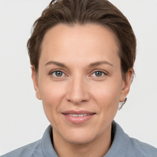 Joyful white adult female with short  brown hair and brown eyes