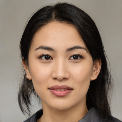 Joyful asian young-adult female with medium  black hair and brown eyes